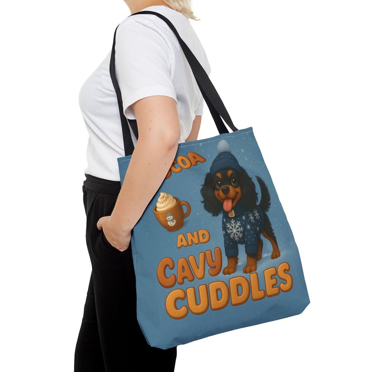 Woman carrying the Black and Tan Cavalier Cocoa and Cavy Cuddles tote at her side, close view