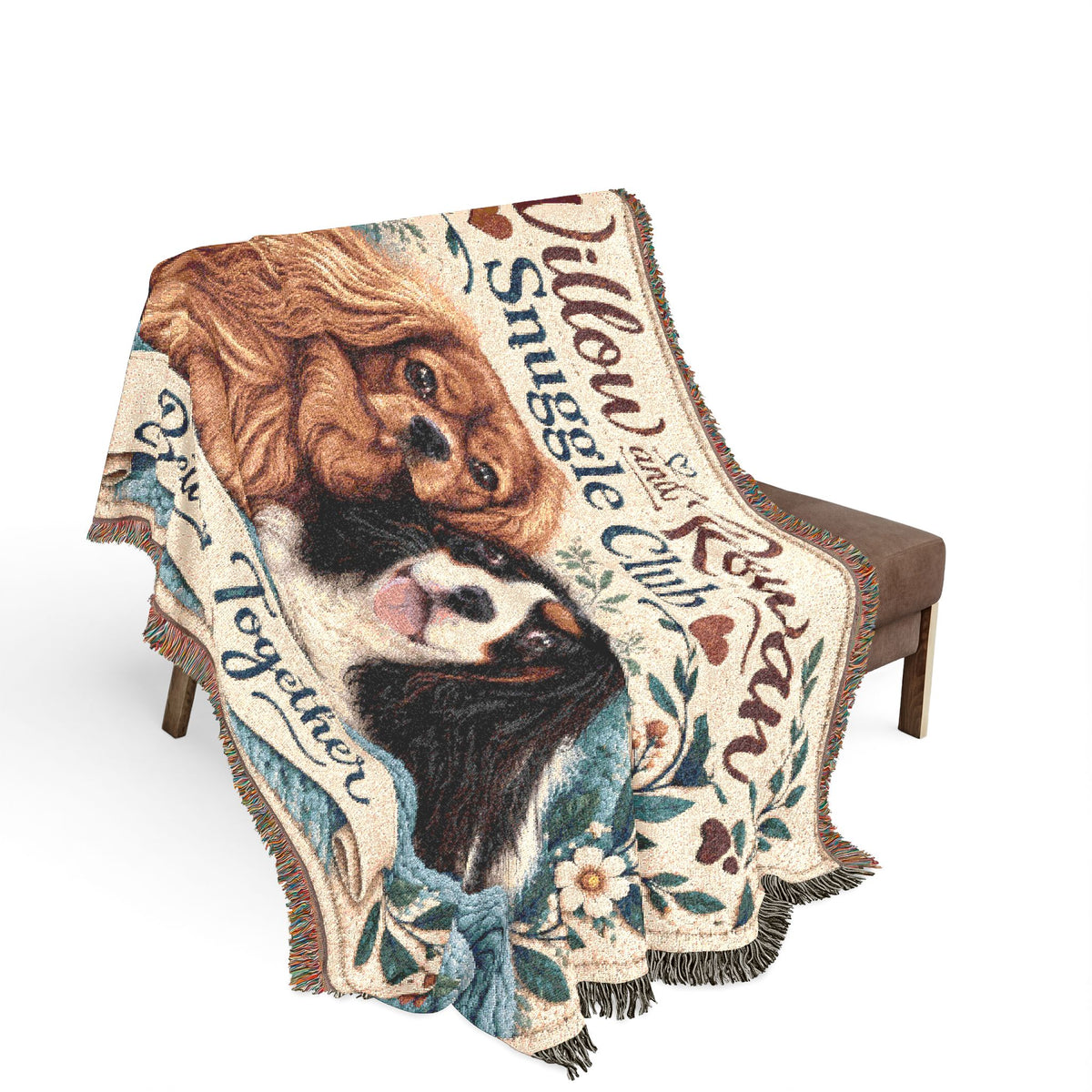 Willow & Rowan Snuggle Club woven blanket draped over a chair, showing the two Cavaliers and fringed edges.
