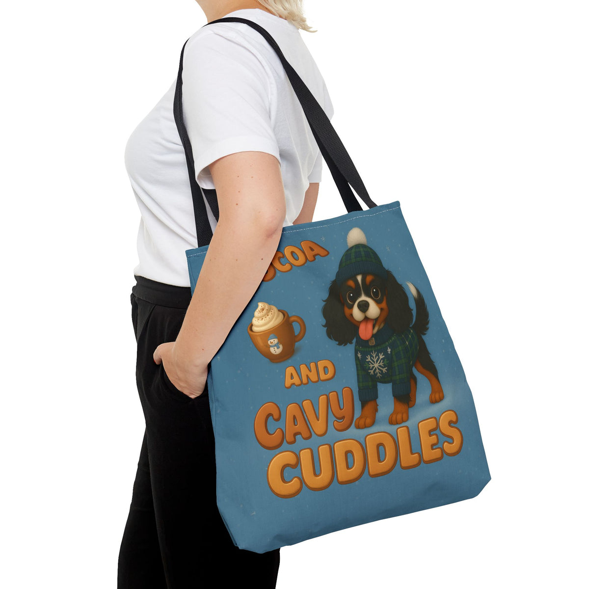 Woman carrying the Tricolor Cavalier Cocoa and Cavy Cuddles tote at her side, close view