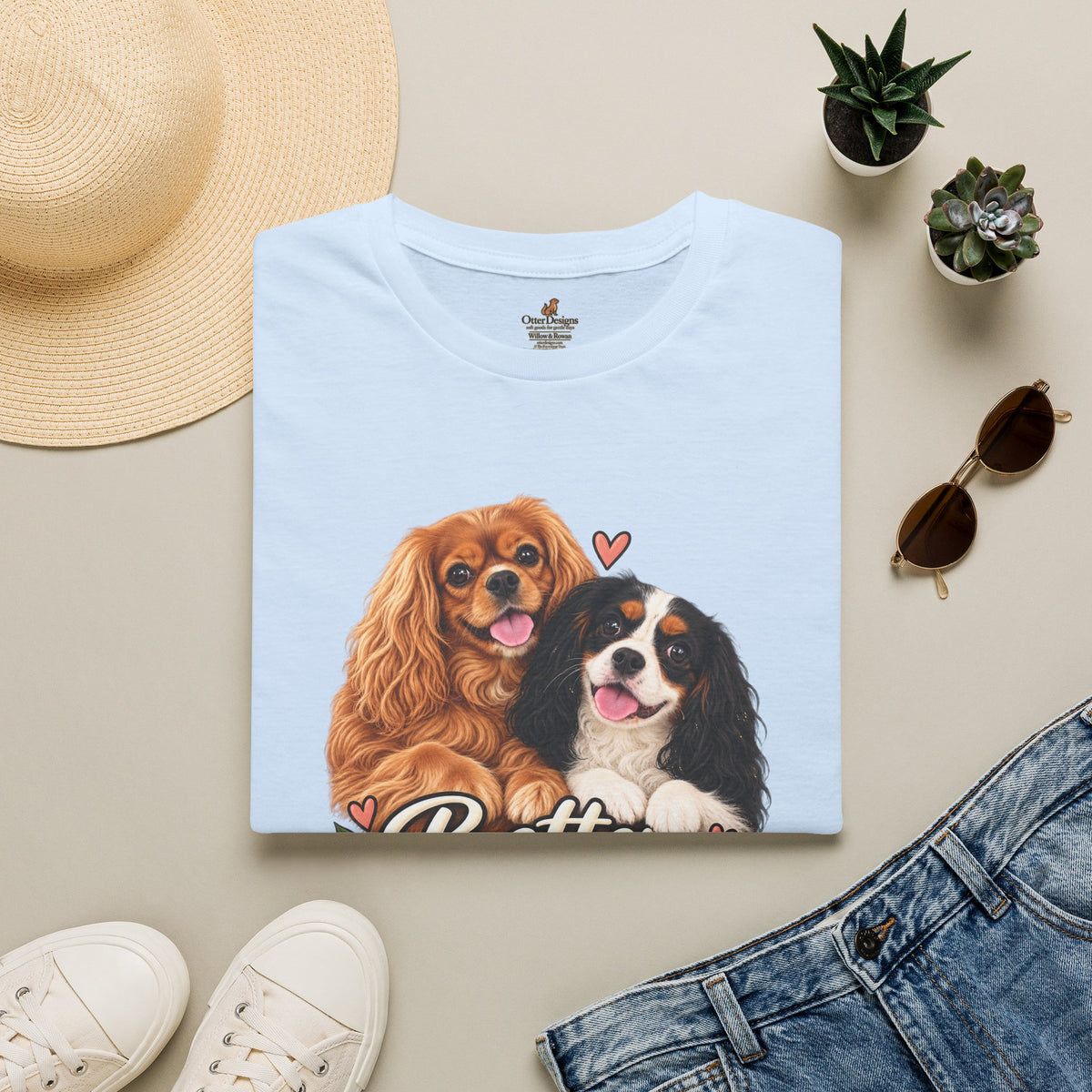 Folded light blue Better Together Cavalier T-shirt styled with jeans and accessories.