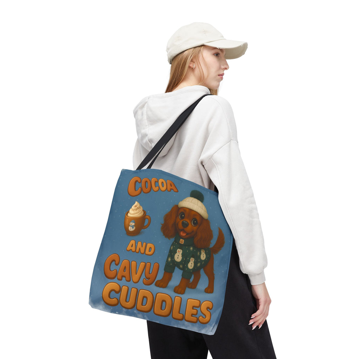 Woman in a cap carrying the Ruby Cavalier Cocoa and Cavy Cuddles tote over her shoulder, back view
